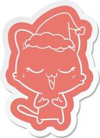 autocollant de dessin animé heureux d'un chat portant un bonnet de noel vecteur