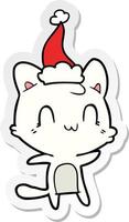 caricature d'autocollant d'un chat heureux portant un bonnet de noel vecteur