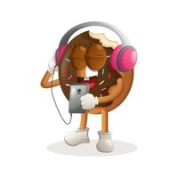 jolie mascotte de beignet écoutant de la musique sur un smartphone à l'aide d'un casque vecteur