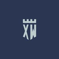 monogramme du logo xw avec un château de forteresse et un design de style bouclier vecteur