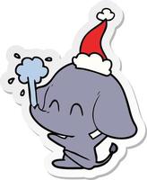 dessin animé mignon autocollant d'un éléphant jaillissant de l'eau portant un bonnet de noel vecteur