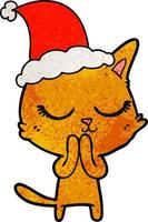 dessin animé texturé calme d'un chat portant un bonnet de noel vecteur