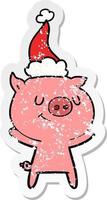 dessin animé autocollant en détresse heureux d'un cochon portant un bonnet de noel vecteur