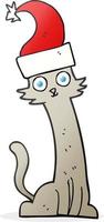 chat de dessin animé dessiné à main levée au chapeau de noël vecteur