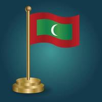 drapeau national des maldives sur le poteau d'or sur fond sombre isolé de gradation. drapeau de table, illustration vectorielle vecteur