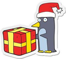 autocollant d'un pingouin de noël dessin animé avec cadeau vecteur