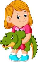 une petite fille tenant un crocodile vecteur