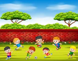 les enfants jouent au football avec leur équipe ensemble dans la cour vecteur