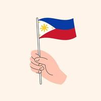 dessin animé main tenant le drapeau philippin, dessin vectoriel isolé