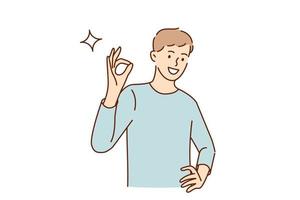 ok concept de langue des signes et des gestes. jeune homme souriant personnage de dessin animé debout montrant le signe ok avec les doigts regardant l'illustration vectorielle de la caméra vecteur