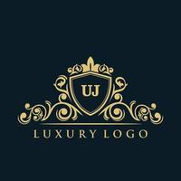 logo lettre uj avec bouclier d'or de luxe. modèle vectoriel de logo d'élégance.