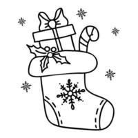 chaussette de noël avec des cadeaux et un bâton de caramel. dessin vectoriel à la main dans un style doodle. pour la décoration de vacances, le design, la décoration et l'impression.