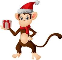 mignon petit singe en bonnet de noel tenant une boîte cadeau vecteur