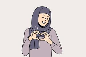 une femme arabe souriante en hijab montre un geste de la main du cœur envoie de l'amour et des soins. une femme arabe heureuse se sent reconnaissante et reconnaissante. notion de gratitude. illustration vectorielle. vecteur