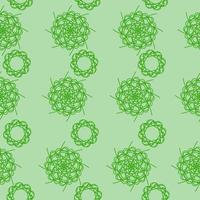 motif harmonieux de mandalas ornés en vert sur fond vert clair, boucles ornées en rangées verticales pour le design vecteur