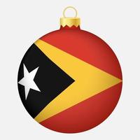 boule de sapin de noël avec le drapeau du timor oriental. icône pour les vacances de noël vecteur