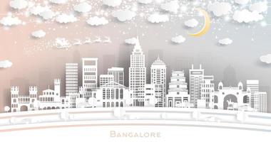 horizon de la ville de bangalore en inde dans un style découpé en papier avec des flocons de neige, une lune et une guirlande de néons. vecteur