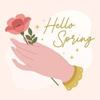 bannière de printemps avec une main féminine tenant une fleur et lettrage dessiné à la main bonjour printemps vecteur
