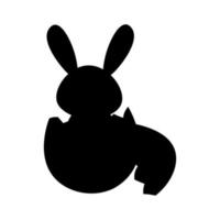 silhouette de une lapin séance dans un coquille d'oeuf vecteur