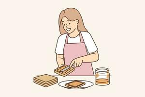 femme se répand cacahuète beurre sur pain en train de préparer sucré petit déjeuner sandwich et sourit comme anticipe délicieux dessert. positif fille portant tablier utilisation cacahuète beurre ou abricot confiture fabrication des sandwichs vecteur