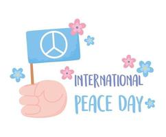 journée internationale de la paix main tenant une carte de fleurs de drapeau vecteur