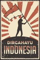 affiche rétro de l'indonésie joyeuse fête de l'indépendance avec l'homme levant le drapeau vecteur