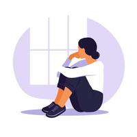femme en dépression avec des pensées déconcertées dans son esprit. jeune fille triste assise dans la fenêtre et serrant ses genoux. style plat vecteur