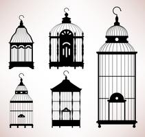 Silhouettes vintage de cage à oiseaux. vecteur