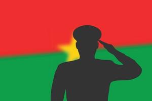 silhouette de soudure sur fond flou avec le drapeau du Burkina Faso.