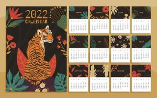 Calendrier imprimable 2022 avec illustrations de tigres et de feuillages floraux vecteur