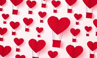 saint valentin, montgolfière en forme de coeur volant dans le ciel, style art papier vecteur