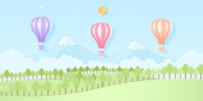 montgolfières colorées volant au-dessus de la montagne, de la colline naturelle et des arbres avec soleil et ciel bleu, style art papier vecteur