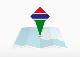 Gambie est représenté sur une plié papier carte et épinglé emplacement marqueur avec drapeau de Gambie. vecteur