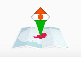 Niger est représenté sur une plié papier carte et épinglé emplacement marqueur avec drapeau de Niger. vecteur
