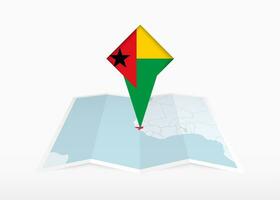 guinée-bissau est représenté sur une plié papier carte et épinglé emplacement marqueur avec drapeau de guinée-bissau. vecteur