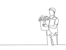 dessin au trait continu unique jeune homme séduisant et heureux tenant un sac d'épicerie rempli de besoins quotidiens. acheter des produits biologiques au concept d'épicerie. une ligne dessiner vector illustration de conception graphique