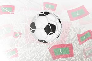 nationale Football équipe de Maldives marqué but. Balle dans objectif filet, tandis que Football partisans sont agitant le Maldives drapeau dans le Contexte. vecteur