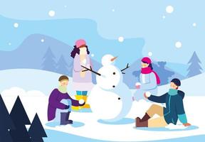 groupe de personnes avec bonhomme de neige dans le paysage d'hiver