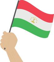 main en portant et élevage le nationale drapeau de le tadjikistan vecteur