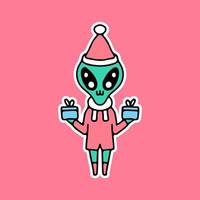 Alien mignon tenant une boîte-cadeau et fêter Noël. dessin animé pour autocollant. vecteur