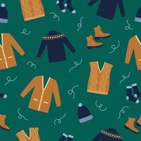 vêtements d'hiver de modèle sans couture. pull bleu, bottes, chaussettes, gilet et cardigan sur fond vert. style de griffonnage. vecteur