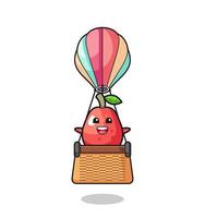 mascotte de pomme d'eau chevauchant une montgolfière