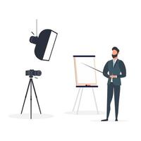 un homme en costume d'affaires avec une cravate fait une présentation à la caméra. le professeur écrit une leçon. le concept de blogging, de formation en ligne et de conférences. appareil photo sur un trépied, softbox. vecteur