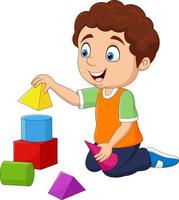 garçon de dessin animé jouant avec des blocs de construction vecteur