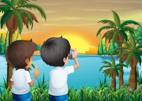 Deux enfants avec une caméra au bord de la rivière vecteur