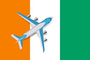 illustration vectorielle d'un avion de passagers survolant le drapeau de la côte d'ivoire. concept de tourisme et de voyage