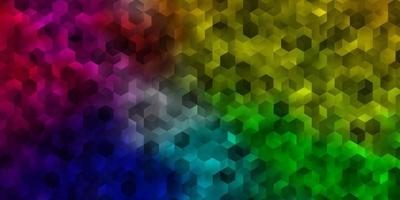 modèle vectoriel multicolore clair avec des hexagones colorés.