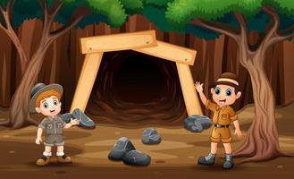 scène avec des garçons explorateurs devant l'illustration de la mine vecteur