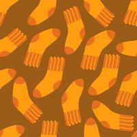 Chaussettes en laine motif harmonieux d'automne orange sur fond marron. illustration vectorielle dans un style plat pour l'impression sur papier, tissu, emballage, textile. vecteur