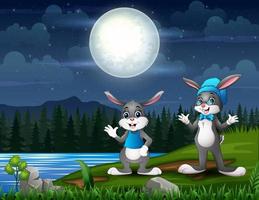 joyeux lapins de pâques au paysage de nuit vecteur